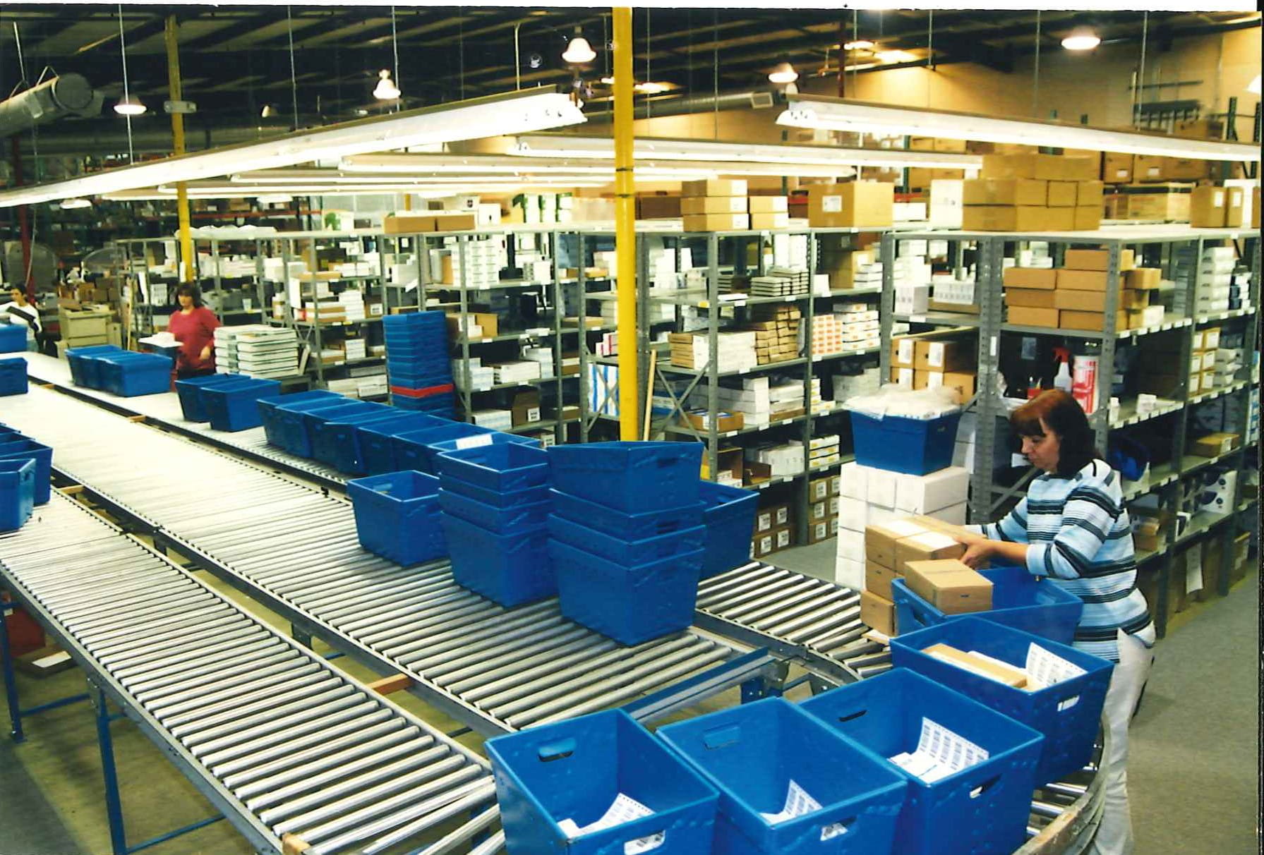 Warehouse conveyor belt with blue bins