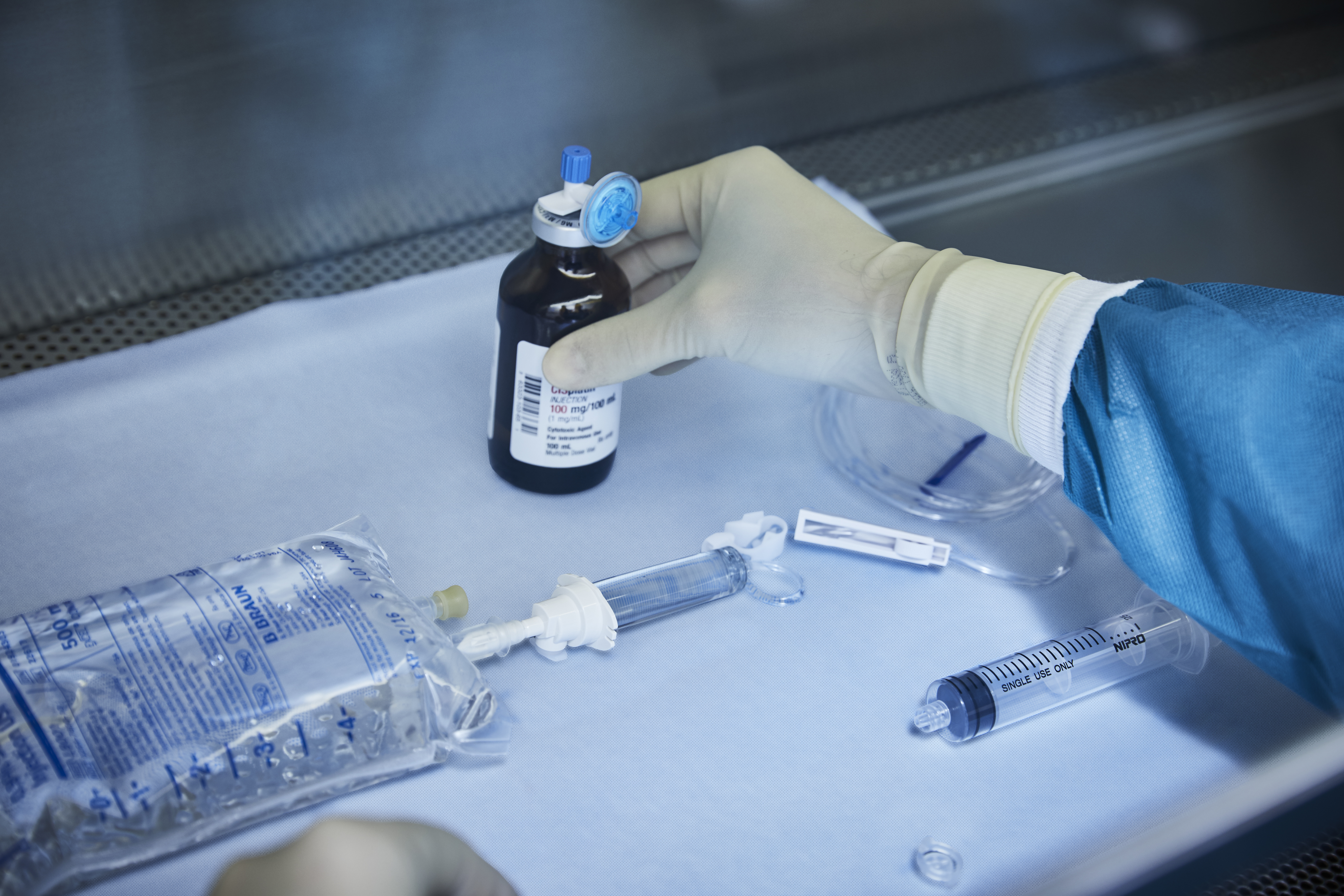 Gloved hand holding pharmaceuticals